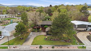 Aerial view of property and surrounding area featuring a mountain backdrop