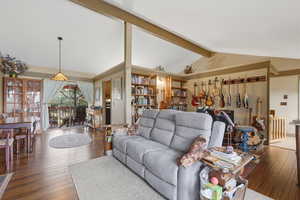 Living area featuring beam ceiling and dark wood finished floors