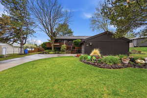 View of front of house featuring concrete driveway and a garage