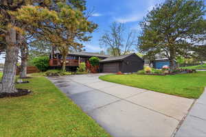 View of front of home featuring a front lawn and concrete driveway
