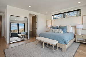 Bedroom with light wood finished floors, access to outside, and recessed lighting