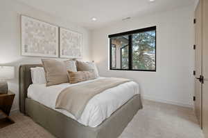 Bedroom featuring light carpet and recessed lighting