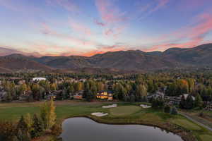 Mountain view featuring a golf course and a large body of water