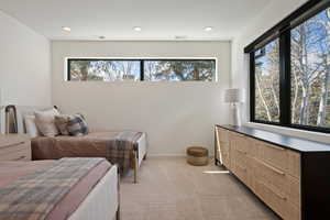 Bedroom featuring light carpet and recessed lighting
