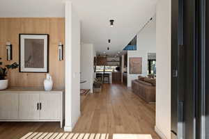 Hallway with light wood finished floors and baseboards