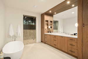 Full bath with double vanity, a soaking tub, a stall shower, light tile patterned floors, and recessed lighting