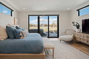 Bedroom featuring light wood-style flooring, access to outside, and recessed lighting