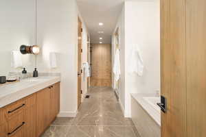 Full bath with recessed lighting, vanity, a bath, a shower stall, and dark marble finish floors