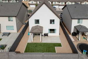 Rear view of house with stucco siding, a residential view, and a patio