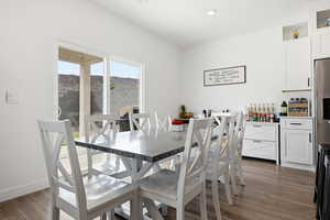 Dining space featuring dark wood finished floors and recessed lighting