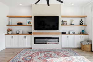 Living area with light wood finished floors, ceiling fan, and recessed lighting