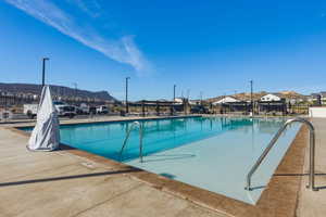 Community pool with a patio area and a mountain view