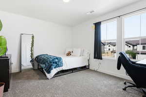 Carpeted bedroom with baseboards