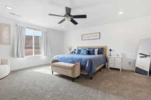 Carpeted bedroom featuring ceiling fan and recessed lighting