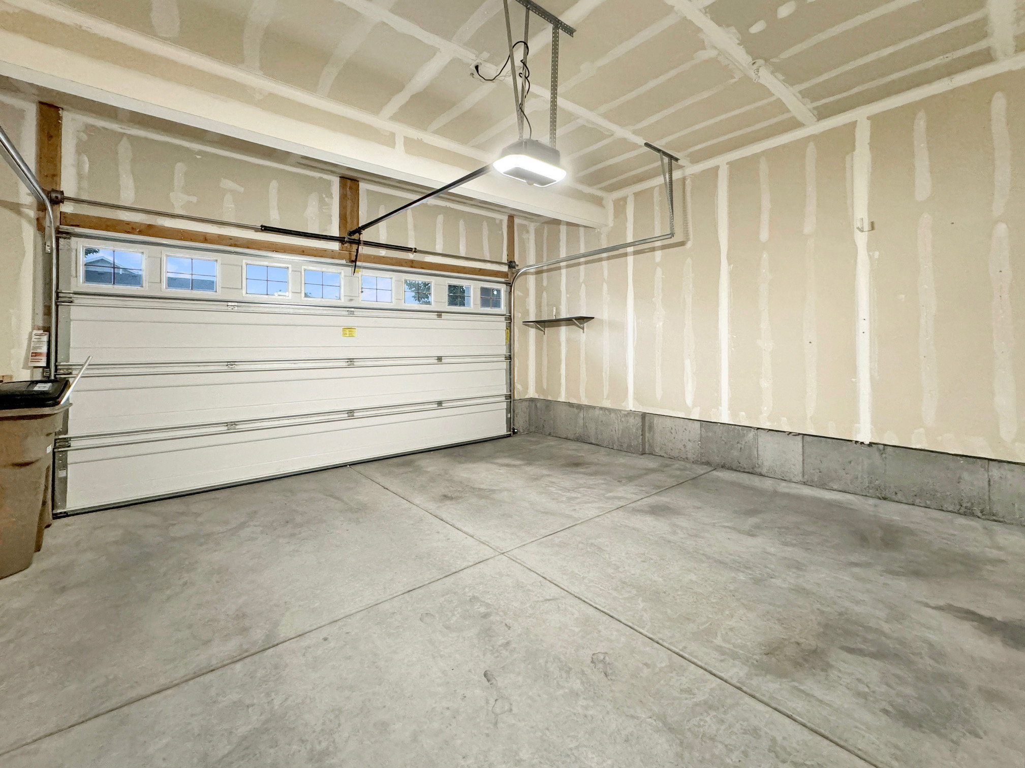 Oversized garage with tall ceilings for storage racks.