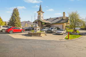 View of clubhouse and uncovered parking