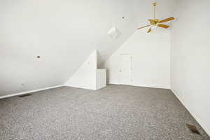 Additional living space (Bonus Room) with vaulted ceiling, carpet flooring, and a ceiling fan