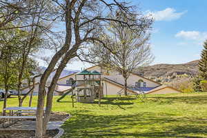 View of community featuring a mountain view and a playground