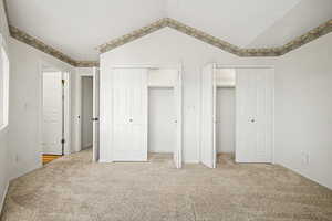 Master Ensuite with multiple closets and light carpet