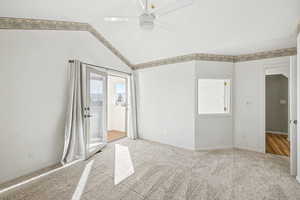 Master Ensuite with lofted ceiling, ceiling fan, and light colored carpet