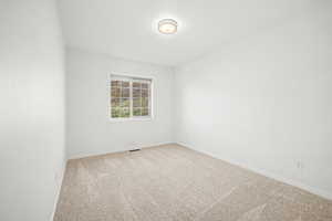 Bedroom 2 with light carpet and baseboards