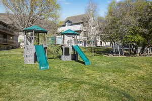 Community playground featuring a lawn