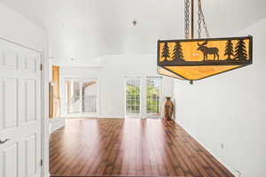 Unfurnished living room featuring dark wood-style flooring and a textured ceiling