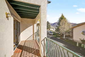 Balcony off living room with a mountain view
