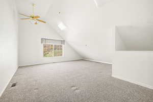 Bonus room featuring lofted ceiling, carpet floors, and 2 ceiling fans