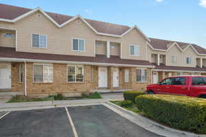 Traditional-style home with brick siding and uncovered parking