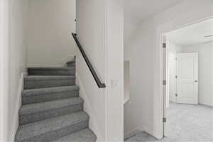 Staircase with baseboards and carpet flooring
