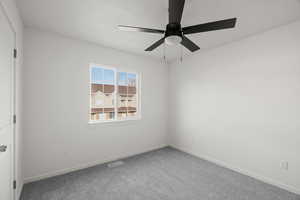 Unfurnished bedroom with carpet floors and ceiling fan