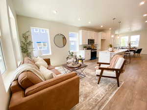 Example: Living area with light wood-style flooring and recessed lighting