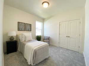 Example: Carpeted bedroom featuring a closet and baseboards