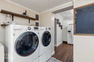 Laundry area featuring dark wood-style flooring and independent washer and dryer