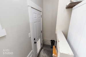 Stairs featuring washer / clothes dryer and concrete flooring
