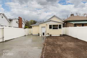 Rear view of house featuring a patio area and a fenced backyard
