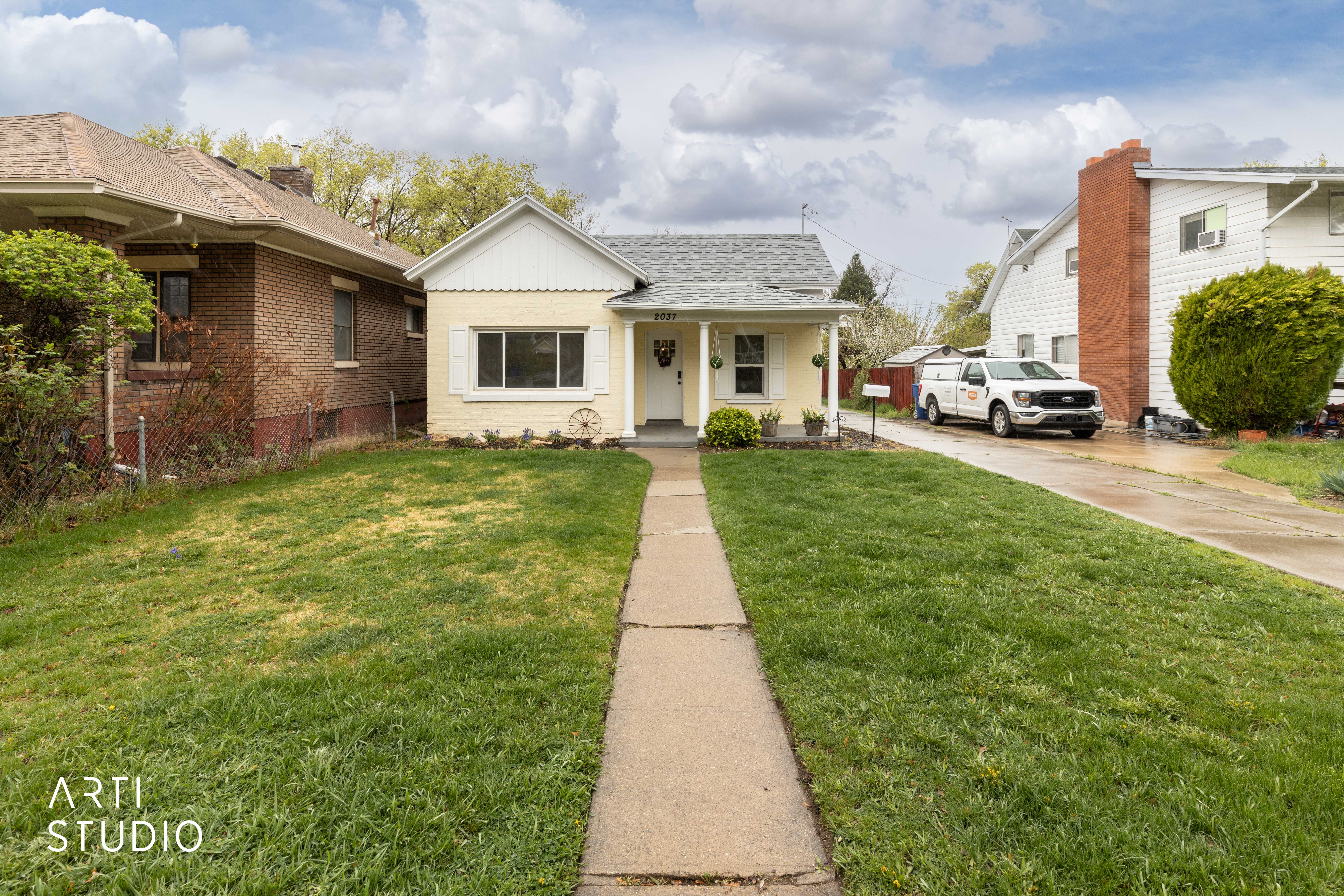 Bungalow-style house featuring a porch, a shingled roof, and driveway