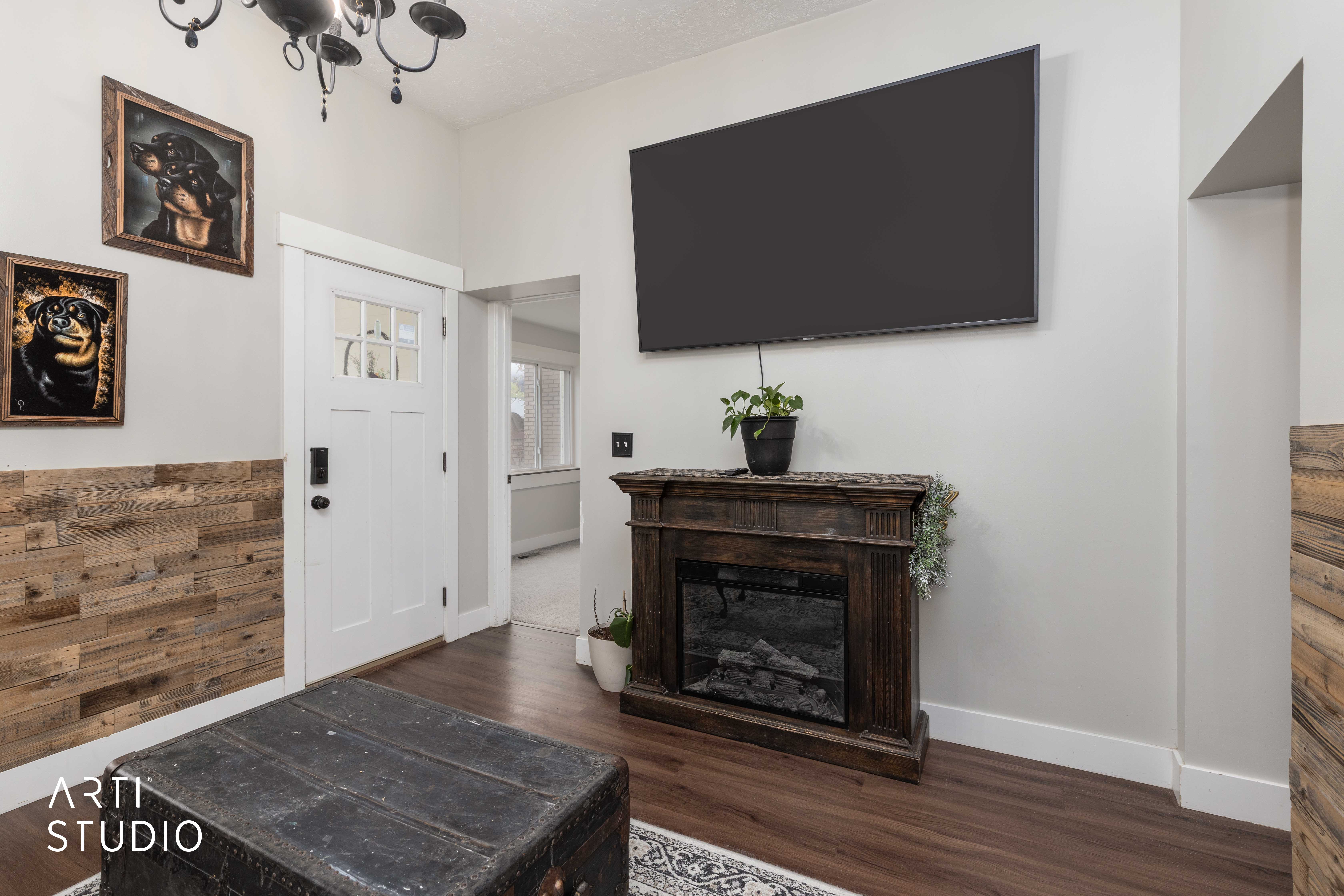 Foyer with dark wood-style floors and baseboards