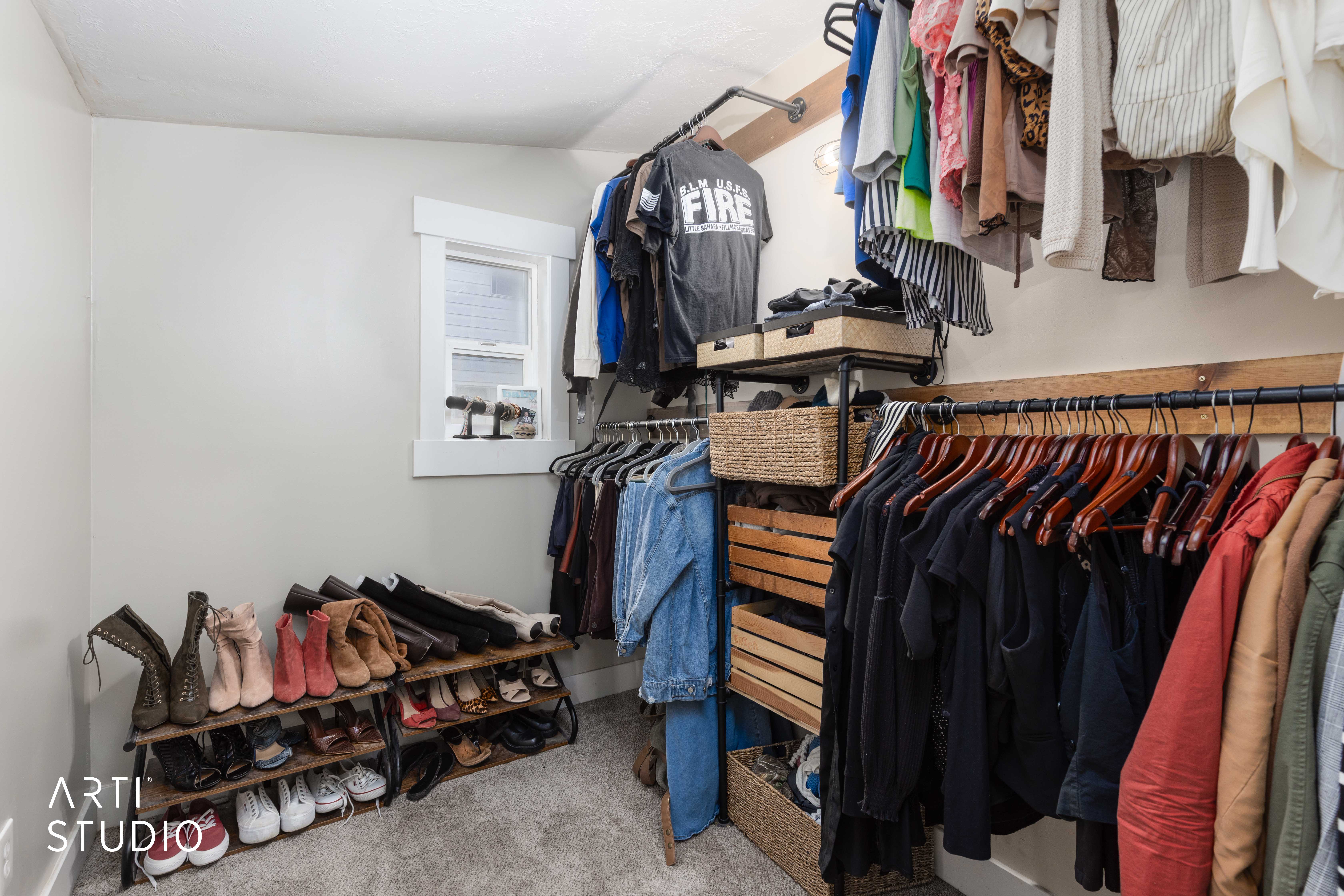 Walk in closet with light colored carpet