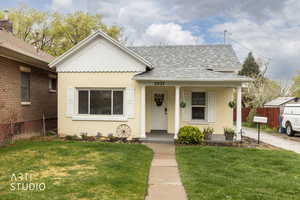 Bungalow-style house with a porch, a shingled roof, and brick siding