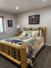 Carpeted bedroom with baseboards and recessed lighting