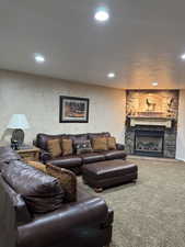 Carpeted living area with a fireplace and recessed lighting