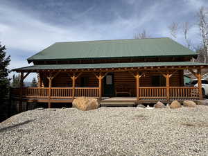 View of front of home featuring a porch and a metal roof