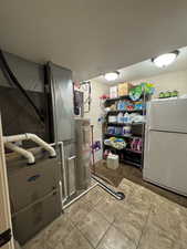 Utility Room with furnace, water heater and shelving