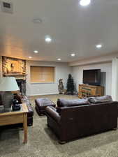 Living room featuring a fireplace, carpet flooring, and recessed lighting