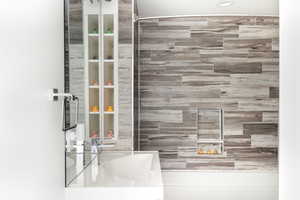 Bathroom featuring  shower combination and vanity