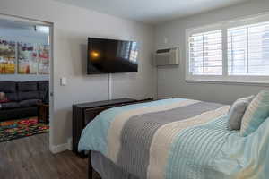 Bedroom with wood finished floors and baseboards