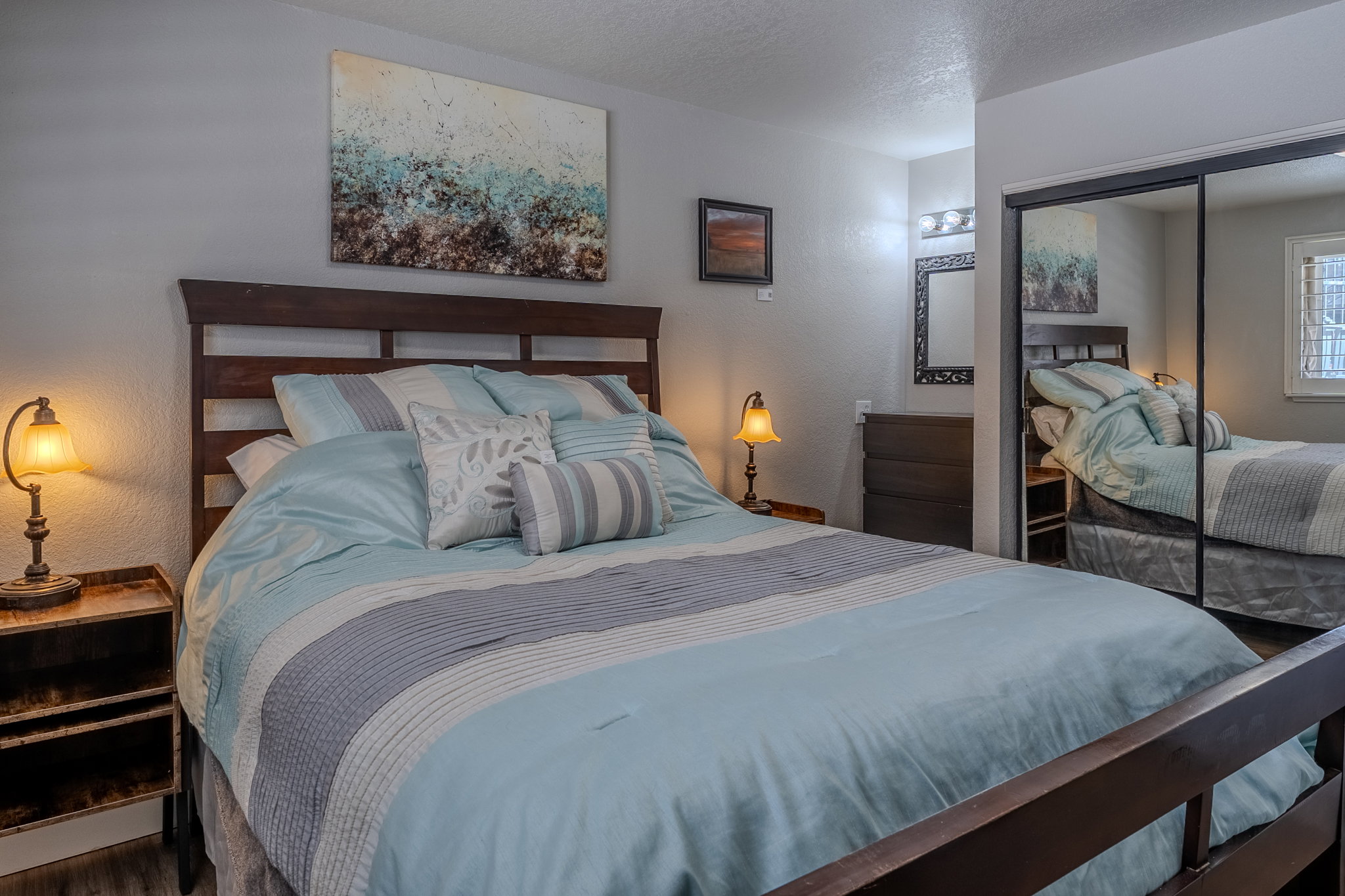 Bedroom featuring a textured ceiling, a textured wall, and a closet