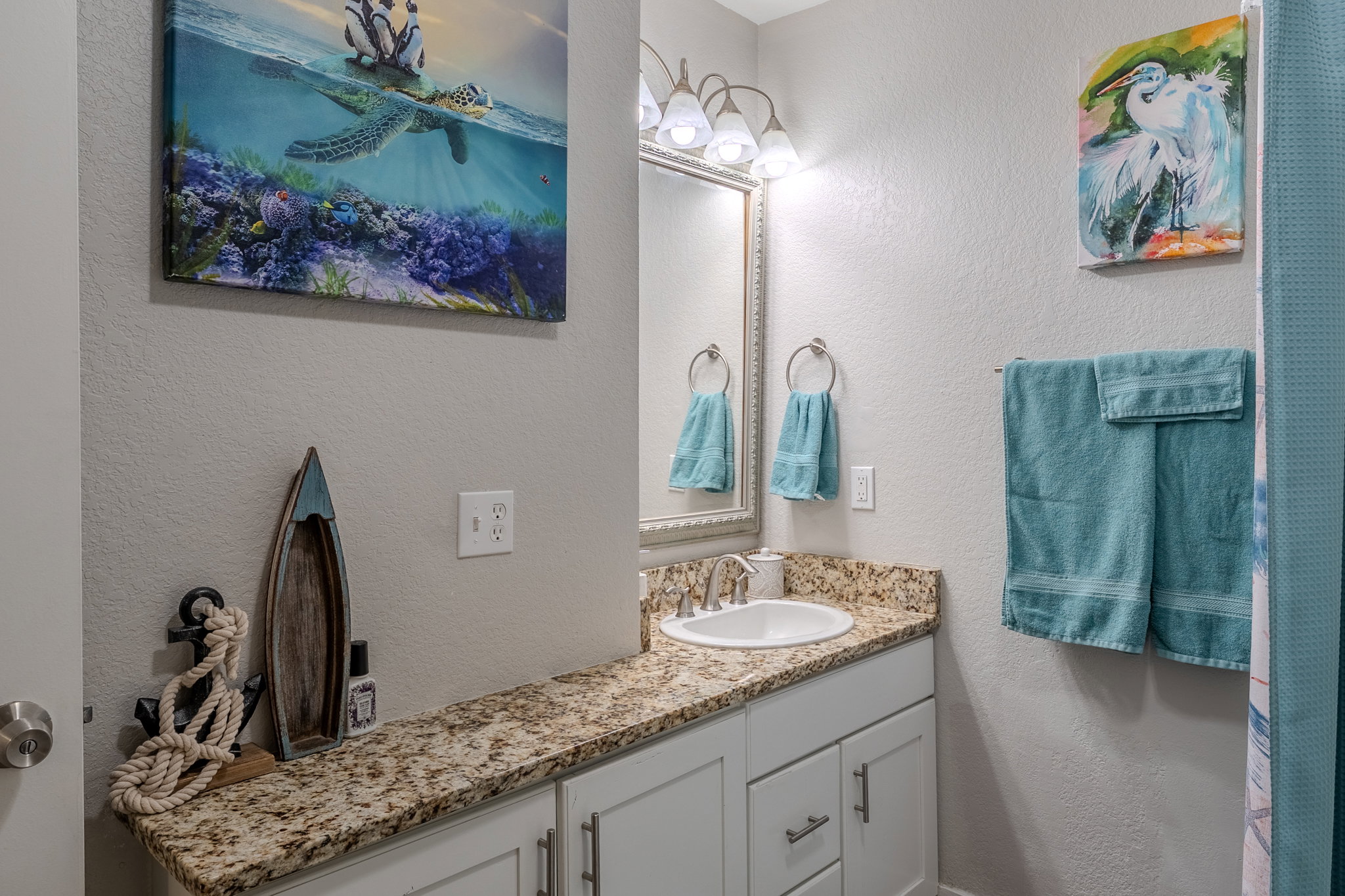 Bathroom with a textured wall and vanity